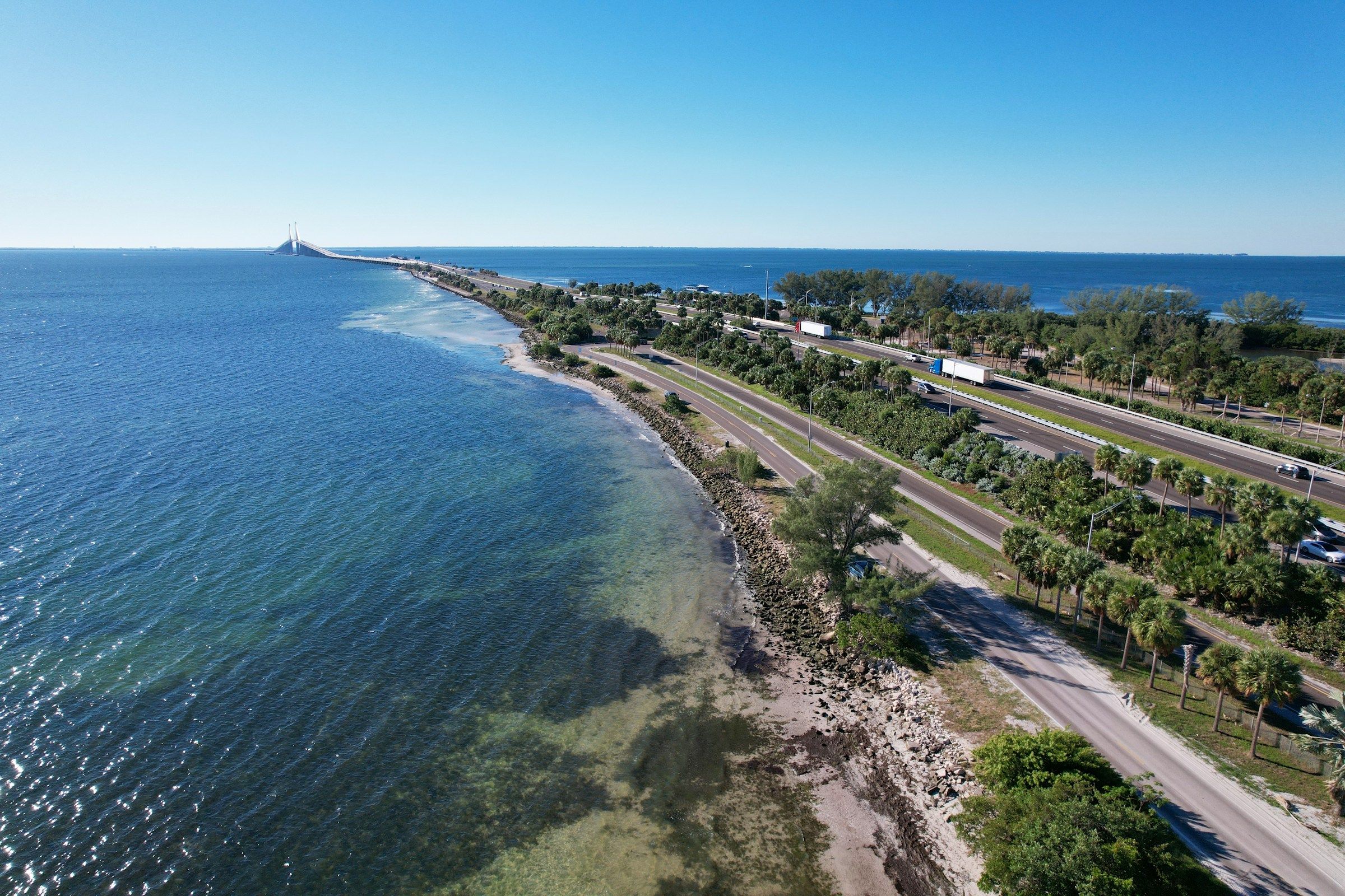 Aerial view of Tampa Bay with the Sunshine Skyway bridge on the horizon